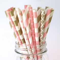 pink and gold striped paper straws in a mason jar