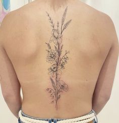 a woman with a flower tattoo on her back