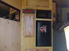 a refrigerator with a horse head on the front and back doors, in a trailer