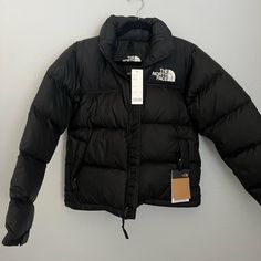 Brand New With Tags, The North Face Retro 1996 Nuptse Jacket In Black. Womens Size Small Stowable Hood Packs Into Collar Exposed, Vislon Center Front Zip Has The Oversize Logos Of The Original ’96 Jacket 700 Fill Goose Down Offers Warmth Yet Remains Extremely Compressible Dwr Finish Helps Keep You Dry 1996 North Face Puffer, Black Northface Puffer Jacket, Northface Jacket Outfit, North Face Puffer Jacket Woman, Northface Puffer Coat, Black North Face Puffer Jacket, Black North Face Puffer, 1996 Nuptse Jacket