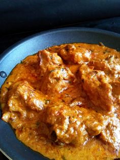 a close up of a plate of food with meat and sauce on it's surface