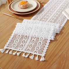 the table is covered with white crocheted doily and placemats on it