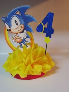 a blue and yellow cake topper with a cartoon character on it