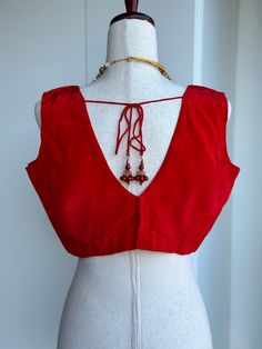 Blouse size 38-42 crape silk sleeveless blouse Elegant Red V-neck Blouse Piece, Silk Sleeveless Blouse For Party, Silk Red Blouse For Party, Red Sleeveless Unstitched Blouse Piece, Red Unstitched Sleeveless Blouse Piece, Elegant Sleeveless Padded Blouse, Elegant Sleeveless Tank Top For Festive Occasions, Red Silk Sleeveless Top, Elegant Sleeveless Red Blouse Piece