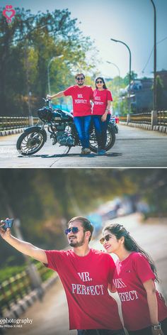 two people in red shirts standing next to a motorcycle