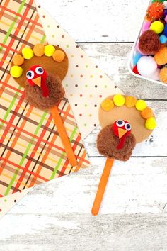 two turkey lollipops are sitting on a table