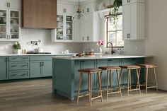 a kitchen with blue cabinets and wooden stools