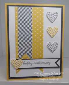 a handmade anniversary card with yellow and white hearts on the front, black and white background