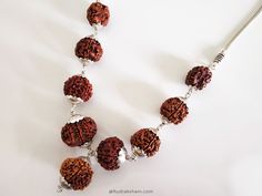 Navgrah Rudraksha Beads Kantha Mala- (Siddha mala) is a Powerful and unique Rudraksha Navagraha Kantha. This Navgrah Rudraksha Beads Kantha consists of Rudrakshas from 2 Mukhi to 9 mukhi (1 each) + 12 Mukhi. There is a silver chain attached to the pendant. This Siddh Mala Silver Pendant appease all the negative planets and gives power to benefic planets. Navgarh Rudraksha kantha is the one pendant, which should definitely be worn by everyone. It does not have any negative effect. It would defini Spiritual Silver Beaded Necklaces For Puja, Spiritual Necklaces With Silver Beads For Puja, Handmade Silver Mala For Spiritual Practices, Handmade Silver Mala Spiritual Style, Spiritual Silver Beads Mala Gift, Silver Mala With Round Beads For Meditation, Handmade Silver Spiritual Mala, Traditional Silver Mala For Meditation, Fusion Style Necklaces For Puja