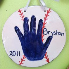 a baseball ornament with a hand painted on it that says, bryson 2011