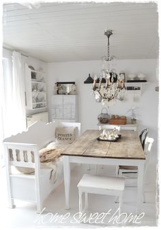 a dining room table with chairs and a chandelier hanging from it's ceiling