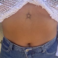 the back of a woman's stomach with a star tattoo on it