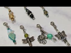 several charms are displayed on a white surface