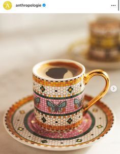 a coffee cup and saucer sitting on top of a table