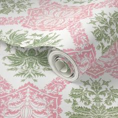 a pink and green wallpaper with an ornate design on it's side,