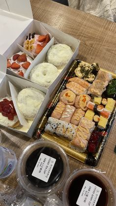 an assortment of sushi and other food items on a table