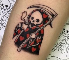 a skull with a sculler holding a knife and heart - shaped bones tattoo on the leg