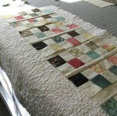 the quilts are laid out on the bed and ready to be sewn together