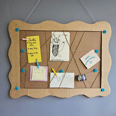 a bulletin board with clothes pins and sticky notes attached to it