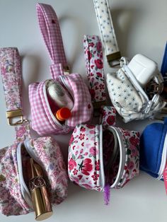 many small purses are lined up on the table with one open and two closed