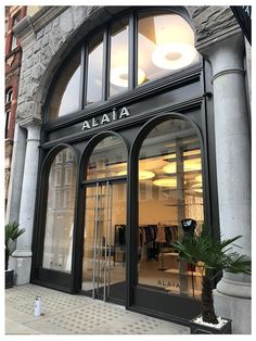 the front entrance to a clothing store with large windows