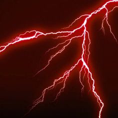 lightning strikes in the night sky with red and white streaks on it's dark background