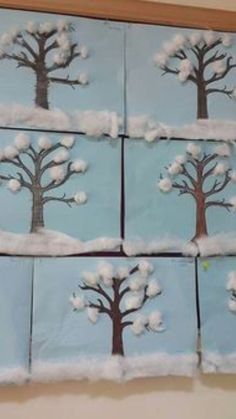 snow covered trees are arranged in squares on the wall