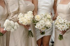 the bridesmaids are holding bouquets of white flowers