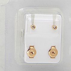 two gold plated earrings in a package