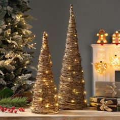 two small christmas trees sitting on top of a table