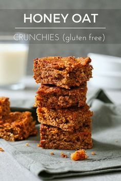 some granola bars stacked on top of each other next to a glass of milk