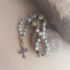 "This handmade gemstone Anglican rosary is made with natural stone Dalmatian Jasper, Black Tourmaline, and Jet. These beautiful semi-precious stone beads have not been dyed and boast earth-made colors. The Cruciform beads are a fair trade African brass. About Praying Rosary: Praying the Rosary can be a tactile aid in helping us to slow down and focus. Rosary beads are a wonderful tool, especially in memorizing scripture and praying God's word back to Him. About Anglican Rosaries ~ the thirty-three bead design was created by the Rev. Lynn Bauman in the mid-1980s, through the prayerful exploration and discovery of a contemplative prayer group. For more information and suggestions for use, go to their website:  All my prayer beads are prayerfully made with joy, gratitude, and love for Jesus. Spiritual Hand-strung Cross Jewelry, 108 Bead Cross Jewelry For Meditation, Spiritual Rosary With Natural Stones As Gift, Handmade Cross Jewelry For Meditation, Spiritual Gemstone Beads Rosary, Bohemian Hand-strung Healing Rosary, Adjustable Bohemian Rosary With Gemstone Beads, Handmade Spiritual Healing Rosary, Bohemian Hand-strung Rosary For Healing