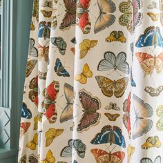 a curtain with butterflies on it in front of a window