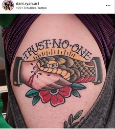 a man with a tattoo on his arm that reads trust no one and has a snake in it