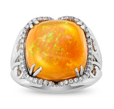 A monumental Ethiopian opal is set in this eye-catching ring. The 11.54-carat stone displays a highly coveted translucent orange hue with a stunning play of color. Diamond accents totaling 0.22 carat surround the rare stone in its unique platinum setting. Ethiopian Opal Ring, Jewelry Real, Rare Stone, Opal Ring, Opal Rings, Ethiopian Opal, M S, Platinum, Opal