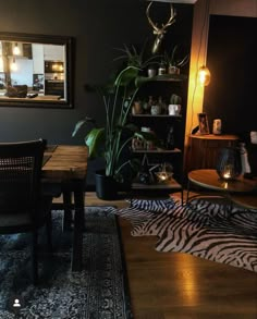 a living room filled with furniture and a zebra rug