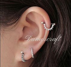 Materials: Sterling Silver Gemstone: Cubic zirconia Location: Cartilage, Earlobe Closure: Screw back Style: Avant garde ◇ Sold in pairs Hoop size: ◇17mm * 8mm ◇Weight: 1.49g ◇ Nickel free ◇ Hypoallergenic All of our jewelry are hypoallergenic and tarnish resistant. We wish to create lasting pieces that everyone can cherish, no matter the price point. O T H E R ∙ I N F O R M A T I O N * All items are nicely packaged ready to gift in elegant jewelry boxes. * If you can't find the information you need or need some advice for your design? Feel free to contact us. We are fast to reply :) T U R N ∙ A R O U N D ∙ T I M E * All items are custom made to order. Our turn around time is about 6 - 10 business days. This can change during peak seasons. Please check our home page for the most current tim Silver Cubic Zirconia Piercings With Sparkling Stones, Minimalist Silver Wedding Piercings, Silver Minimalist Wedding Piercings, Silver Hoop Piercings For Wedding, Dainty Silver Cartilage Earrings For Party, Silver Internally Threaded Cubic Zirconia Cartilage Earrings, Silver Cubic Zirconia Internally Threaded Cartilage Earrings, Silver Hoop Cartilage Earrings Cubic Zirconia, Adjustable Silver Cartilage Earrings With Cubic Zirconia