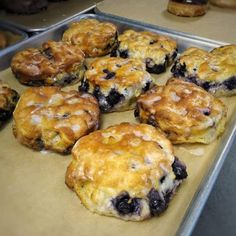 some blueberry muffins are sitting on a baking sheet