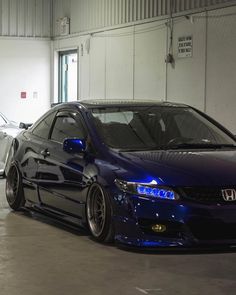 two cars parked in a garage next to each other