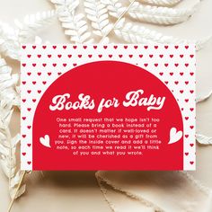 a card that says books for baby on it with hearts and leaves in the background