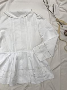 Amazingly detailed vintage 40's/50's blaser or blouse with extreme puff sleeves, peplum and cotton buttons, petern pan collar and cut out lace richelieau with roses. Goes well with an understated crop top and high waisted jeans. Very Rouje-esque, but Eastern European + original. Sits a size small to large. Measurements soon. Excellent condition, rare piece. Victorian Cotton Fitted Blouse, Fitted Victorian Cotton Blouse, Fitted Victorian Tops With Lace Collar, Fitted White Victorian Blouse, White Fitted Victorian Blouse, Fitted Peplum Tops With Lace Trim, Fitted Lace Trim Peplum Top, Vintage Cotton Tops With Bishop Sleeves, Vintage Cotton Blouse With Lace Cuffs