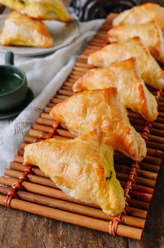 several pastries are lined up on a bamboo mat