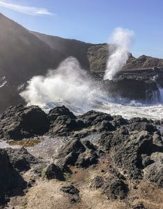 the waves are crashing on the rocky shore