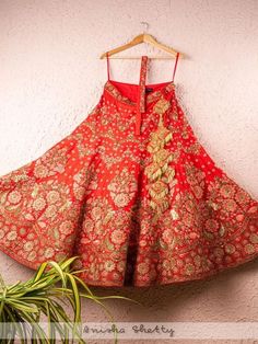 Red And Rose Pink Raw Silk Bridal Lehenga Set (Set of 3) By Anisha Shetty now available at Trendroots Traditional Floral Embroidered Gown For Navratri, Traditional Gown With Floral Embroidery For Reception, Traditional Reception Gown With Floral Embroidery, Traditional Art Silk Gown With Floral Embroidery, Traditional Red Gown With Floral Embroidery, Red Sharara With Floral Embroidery For Wedding, Traditional Red Sharara With Floral Embroidery, Red Anarkali Lehenga With Floral Embroidery, Red Floral Embroidered Lehenga For Navratri