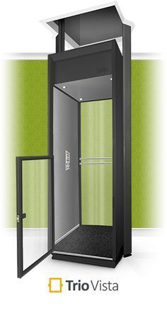 an open shower stall with green walls and black floor, in front of a white wall