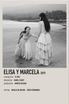 two women in dresses holding hands on the beach