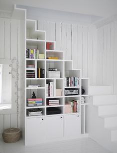 a white book shelf filled with lots of books