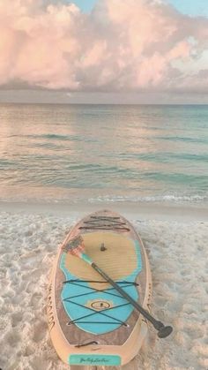 a kayak is sitting on the sand at the beach