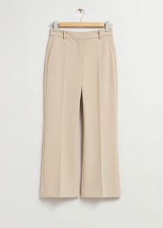 High-waist trousers featuring a kick-flare, angle-length silhouette. Finished with press creases.Zip fly with button closureSlanted side pocketsWelt back pocketsLength of inseam: 69.5cm / 27.4" (EU 36 / UK 8 / US 4) Chic Flared Bottoms With Pressed Crease, Tailored Flare Bottoms With Pressed Crease, Flare Pants With Pockets For Work, Classic Flare Pants With Pockets, Flare Bottoms With Pockets For Workwear, Elegant Flared Bottoms With Pockets, Beige Flare Pants For Work, Beige Flare Bottoms For Workwear, Tan Pants Outfit