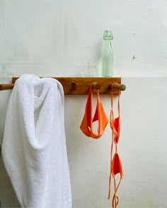 towels hanging on a towel rack next to a bottle